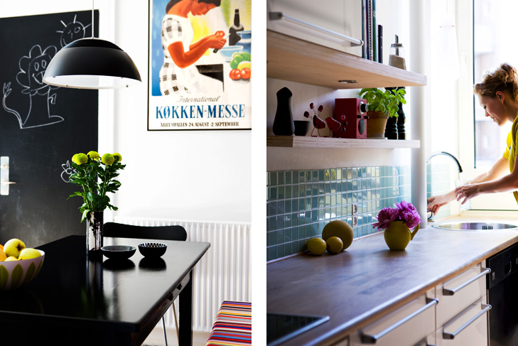 Indretning af køkken med spisebord og plakat i baggrunden samt køkkenbord med glasfliser, blomster og køkkenvask